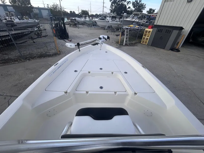 Slide: The Image of 2013 Skeeter SX2250 boat deck view in a marina setting. - 18