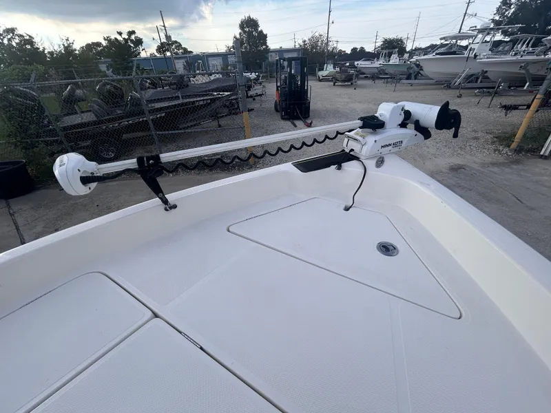 Slide: The Image of 2013 Skeeter SX2250 boat with trolling motor in a marina setting. - 19