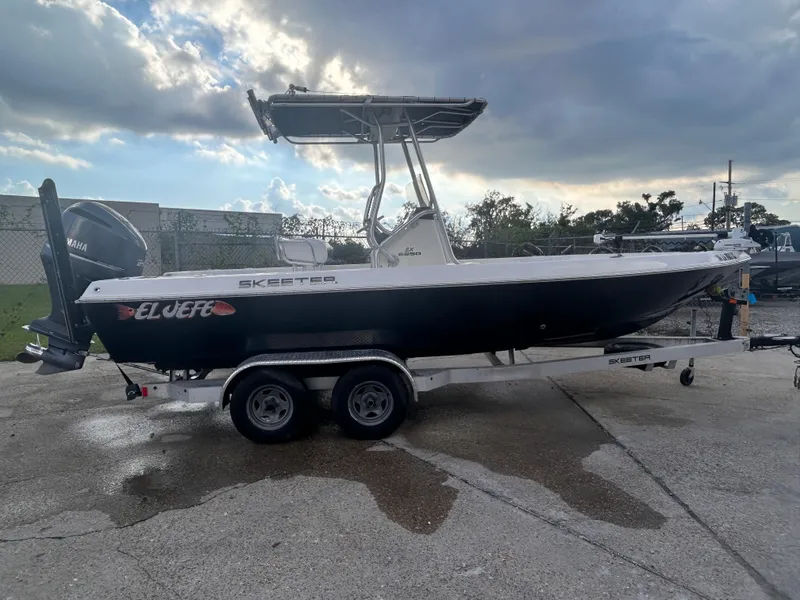 Slide: The Image of 2013 Skeeter SX2250 boat on trailer under cloudy sky. - 8