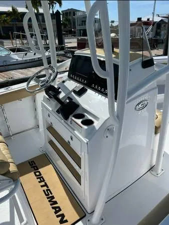 Slide: The Image of 2021 Sportsman Heritage 231 Center Console boat interior with steering wheel and control panel. - 3