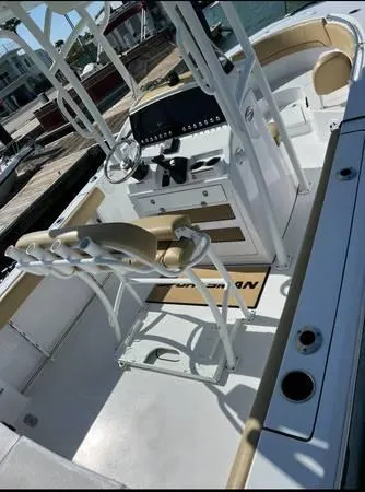 Slide: The Image of 2021 Sportsman Heritage 231 Center Console boat interior with helm and seating. - 4