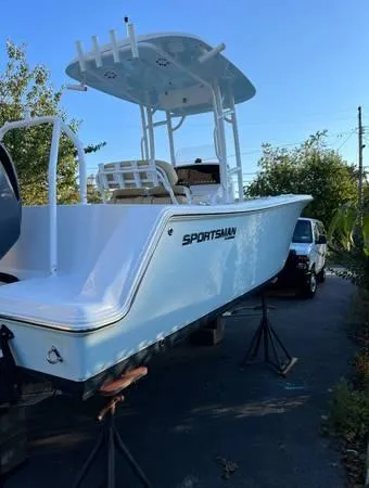 Slide: The Image of 2021 Sportsman Heritage 231 Center Console boat on stands, outdoor setting. - 6