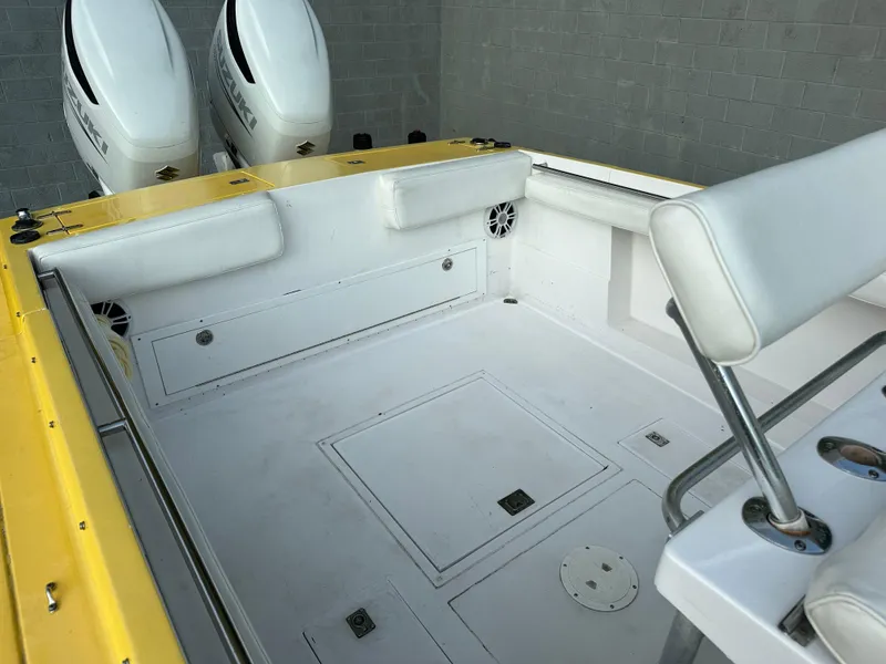 Slide: The Image of 1988 Wellcraft SCARAB SPORT boat interior with dual engines, yellow and white design. - 11