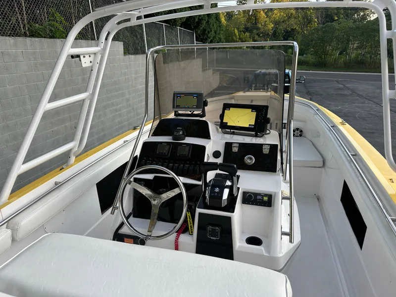 Slide: The Image of 1988 Wellcraft SCARAB SPORT boat interior with steering wheel and navigation equipment. - 13