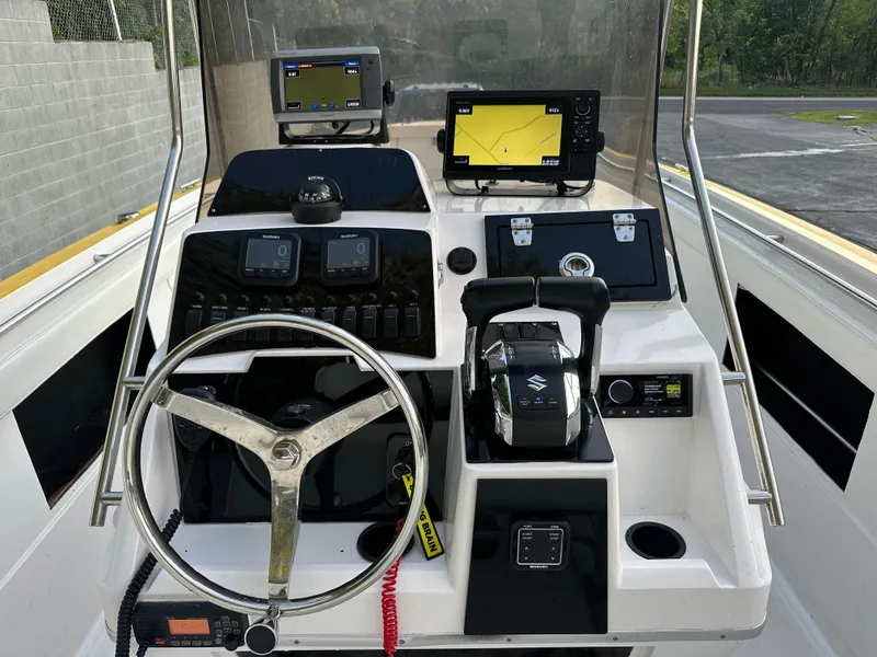 Slide: The Image of 1988 Wellcraft SCARAB SPORT boat dashboard with steering wheel and navigation equipment. - 14