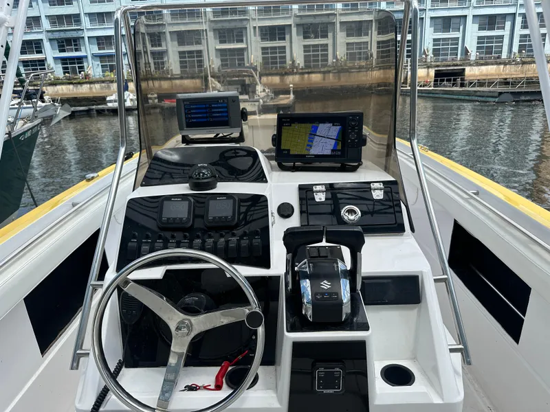 Slide: The Image of 1988 Wellcraft SCARAB SPORT boat dashboard with steering wheel and navigation equipment. - 15