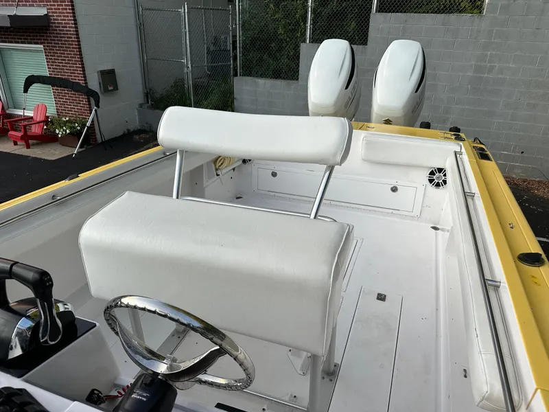 Slide: The Image of 1988 Wellcraft SCARAB SPORT boat interior with white seating and dual engines. - 17