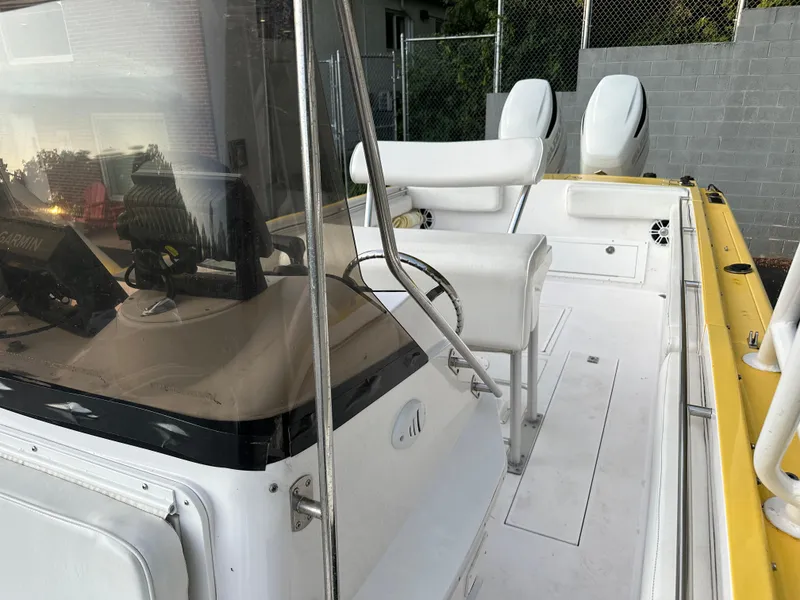 Slide: The Image of 1988 Wellcraft SCARAB SPORT boat interior with white seating and dual engines. - 18