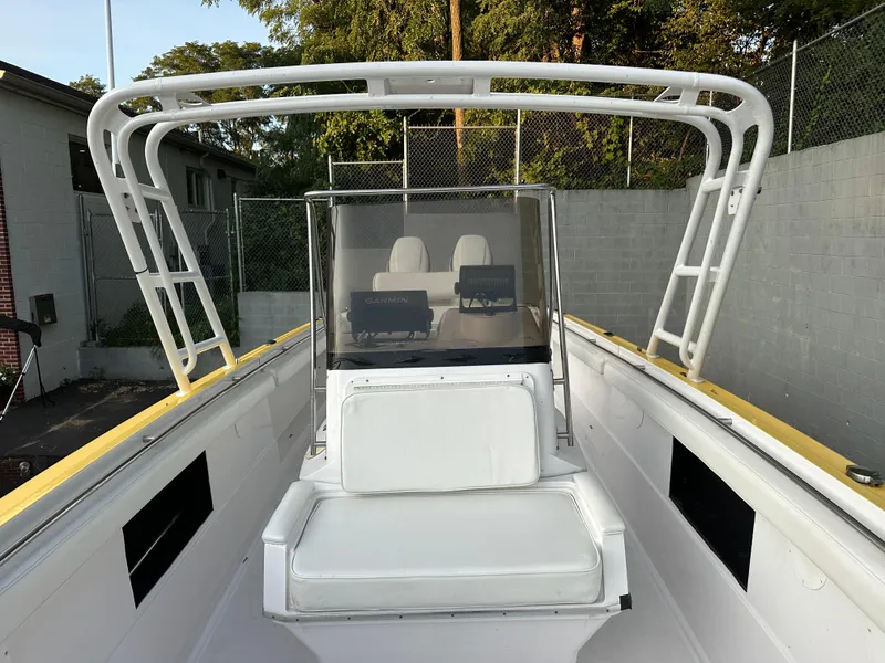 Slide: The Image of 1988 Wellcraft SCARAB SPORT boat with white seating and T-top, docked outdoors. - 19