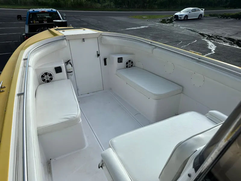 Slide: The Image of 1988 Wellcraft SCARAB SPORT boat interior with white seating and speakers. - 20
