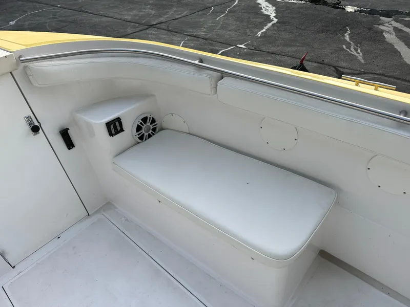 Slide: The Image of 1988 Wellcraft SCARAB SPORT boat interior with white seating and speaker. - 23