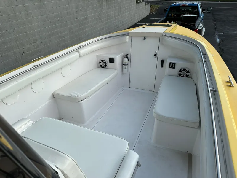 Slide: The Image of 1988 Wellcraft SCARAB SPORT boat interior with white seating and speakers. - 24