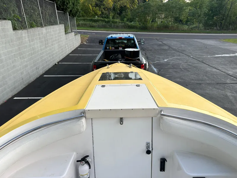 Slide: The Image of 1988 Wellcraft SCARAB SPORT boat on trailer, parked in lot with pickup truck. - 25