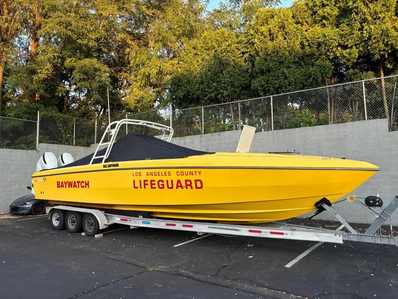 Slide: The Image of 1988 Wellcraft SCARAB SPORT lifeguard boat on trailer, yellow with "Baywatch" and "Los Angeles County Lifeguard" - 5