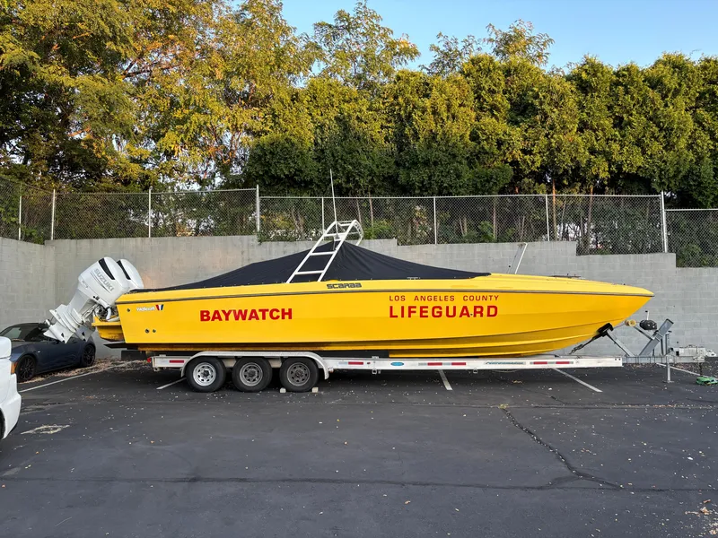 Slide: The Image of 1988 Wellcraft SCARAB SPORT boat, yellow Baywatch lifeguard design, parked on trailer. - 6