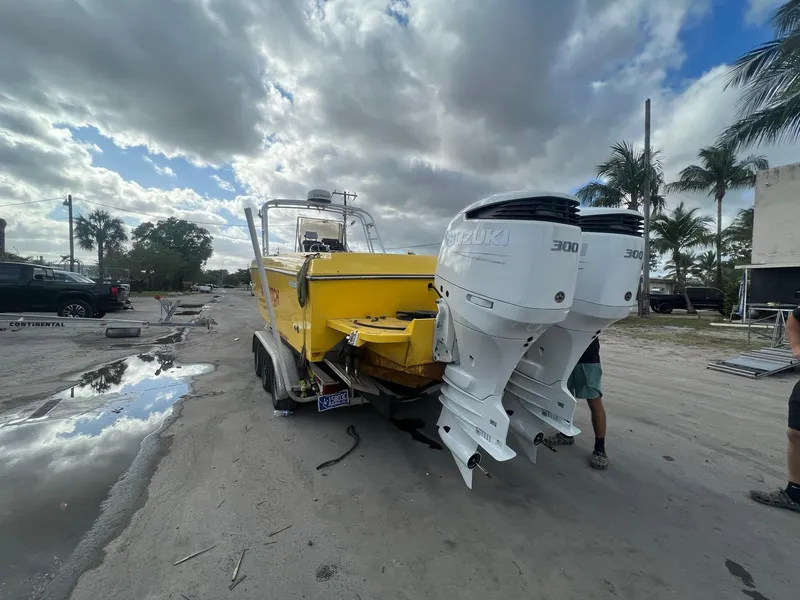 Slide: The Image of 1988 Wellcraft SCARAB SPORT boat with dual Suzuki 300 engines on a trailer. - 8