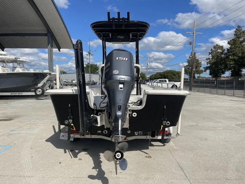 Slide: The Image of 2005 Sea Pro SV2100 boat with Yamaha 150 engine, parked outdoors. - 4