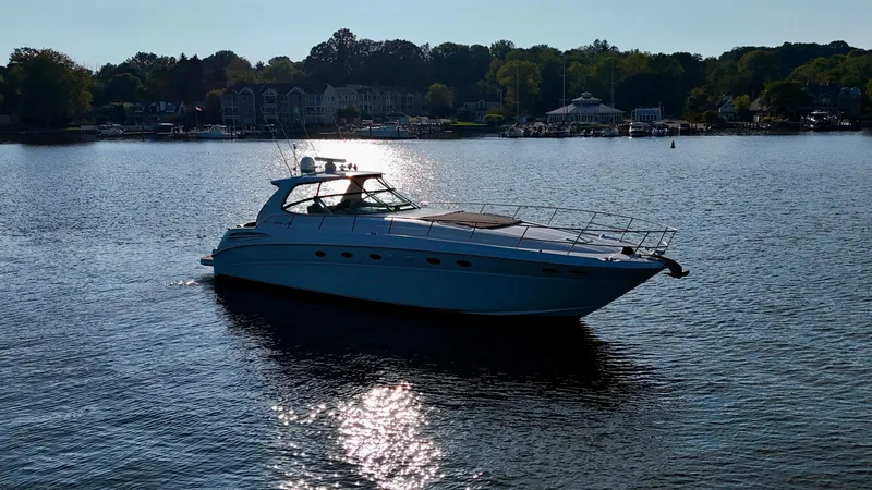 Slide: The Image of 2001 Sea Ray 510 Sundancer yacht cruising on a serene lake. - 14