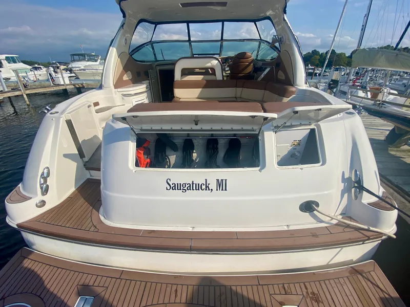 Slide: The Image of 2001 Sea Ray 510 Sundancer docked in Saugatuck, MI, with open storage compartment. - 19