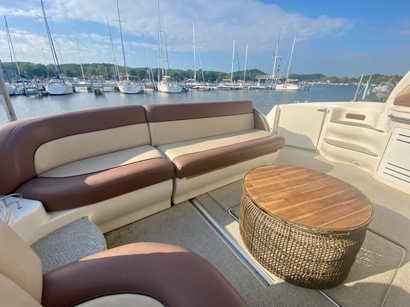 Slide: The Image of Luxurious 2001 Sea Ray 510 Sundancer yacht interior with plush seating and wooden table. - 23