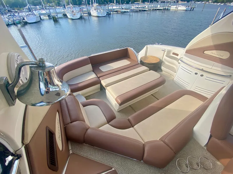 Slide: The Image of Luxurious 2001 Sea Ray 510 Sundancer yacht interior with plush seating and scenic marina view. - 24