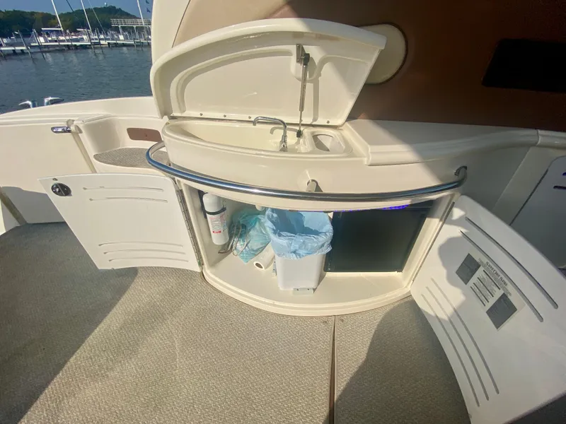Slide: The Image of 2001 Sea Ray 510 Sundancer yacht kitchenette with sink and storage compartments. - 27