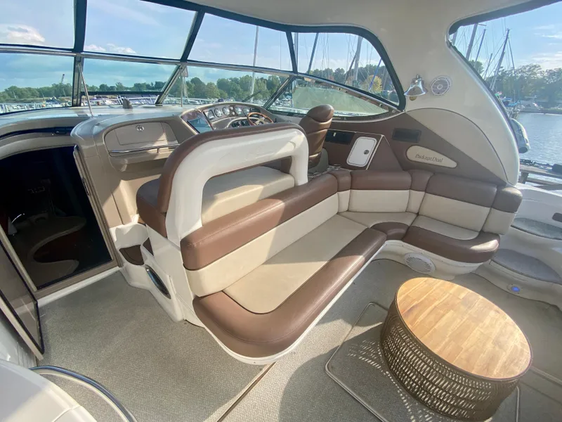 Slide: The Image of Luxurious interior of 2001 Sea Ray 510 Sundancer yacht with plush seating and wooden table. - 28