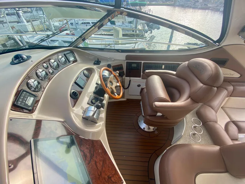 Slide: The Image of Luxurious helm of 2001 Sea Ray 510 Sundancer yacht with leather seating and wood accents. - 29