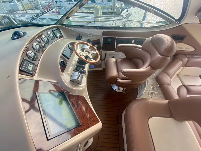 Slide: The Image of Luxurious helm of 2001 Sea Ray 510 Sundancer with leather seating and advanced controls. - 30