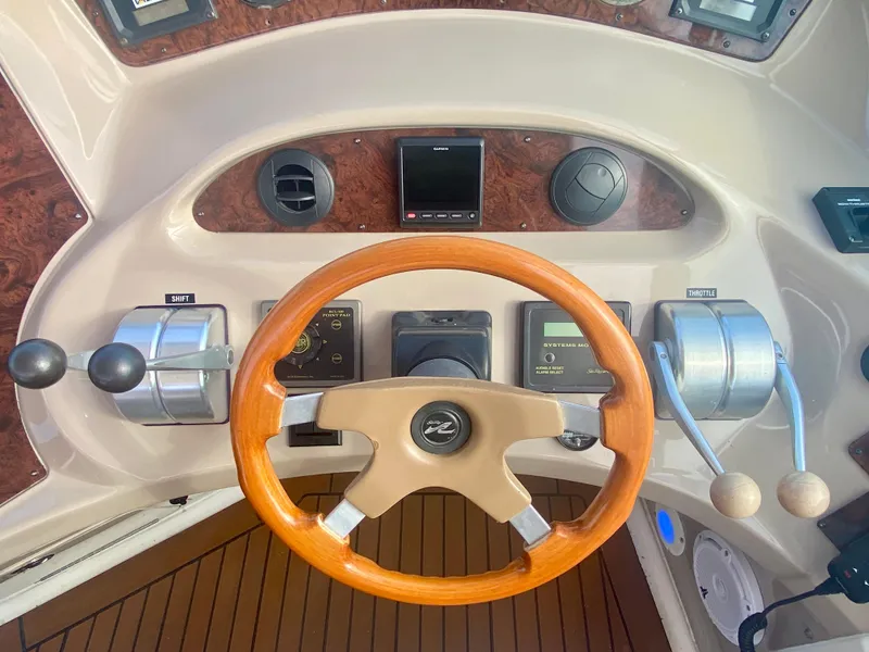 Slide: The Image of Helm of 2001 Sea Ray 510 Sundancer with wooden steering wheel and control panel. - 32