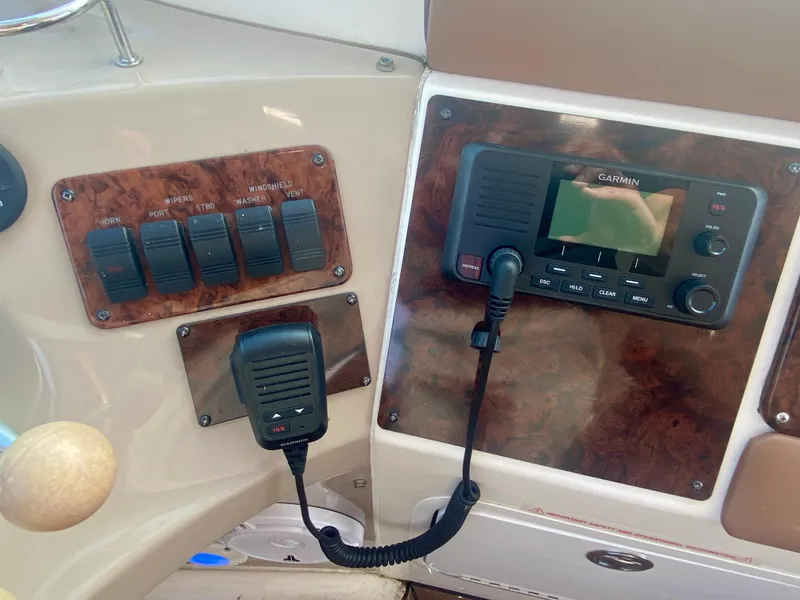 Slide: The Image of Control panel of 2001 Sea Ray 510 Sundancer with Garmin radio and switches. - 35