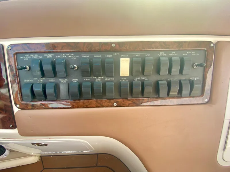 Slide: The Image of Control panel of a 2001 Sea Ray 510 Sundancer boat with various switches. - 36