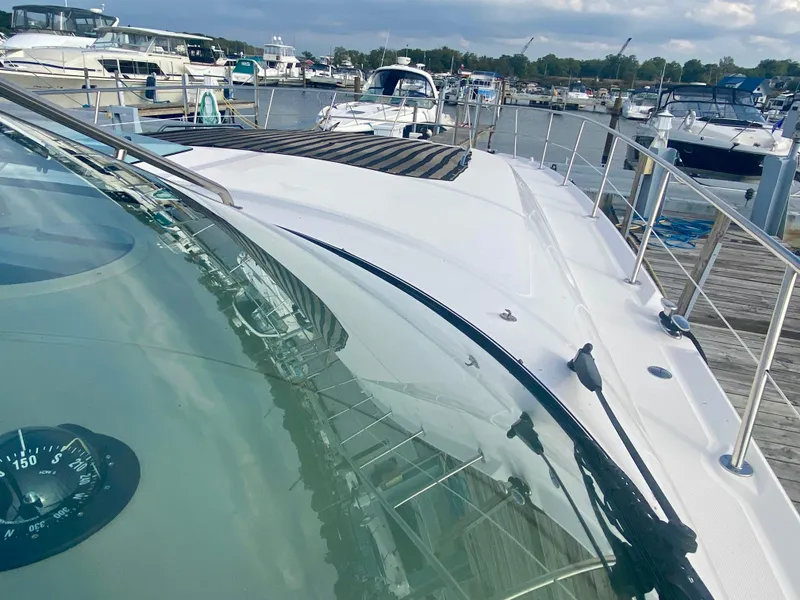 Slide: The Image of 2001 Sea Ray 510 Sundancer yacht docked at marina, showcasing sleek design and spacious deck. - 38