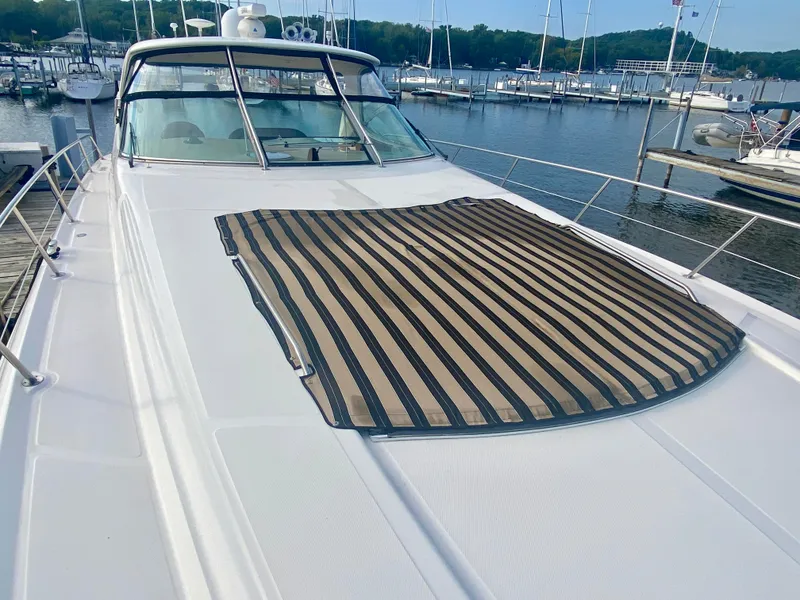 Slide: The Image of 2001 Sea Ray 510 Sundancer yacht with striped deck cover at marina. - 39