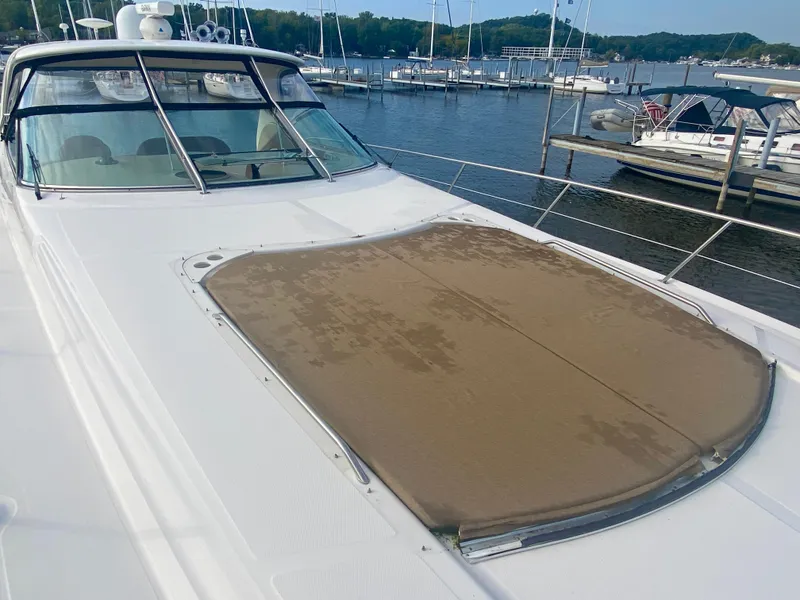 Slide: The Image of 2001 Sea Ray 510 Sundancer yacht docked at marina, featuring spacious deck and sunpad. - 40