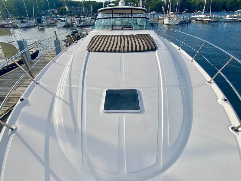 Slide: The Image of 2001 Sea Ray 510 Sundancer yacht docked at marina, showcasing spacious deck. - 41