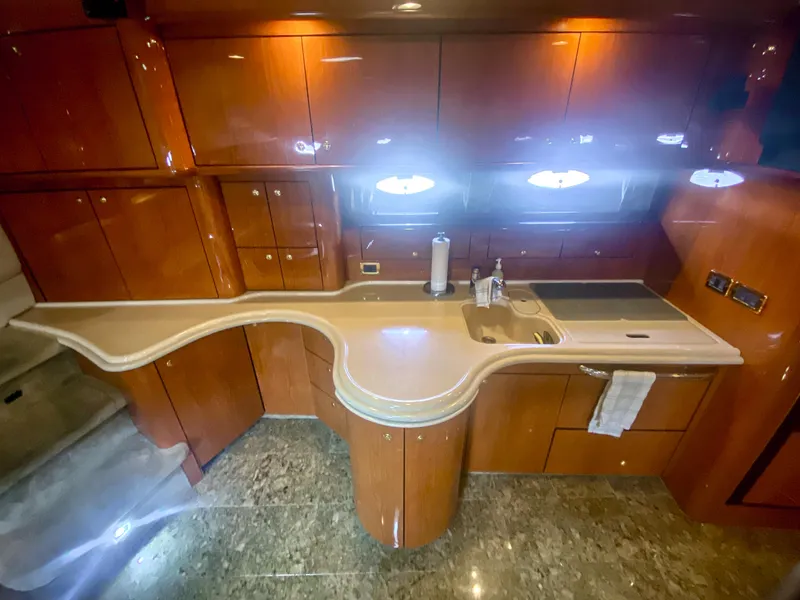 Slide: The Image of Luxurious 2001 Sea Ray 510 Sundancer yacht kitchen with sleek wood cabinetry and modern amenities. - 45