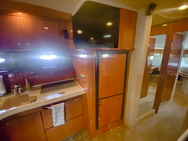 Slide: The Image of Luxurious interior of 2001 Sea Ray 510 Sundancer yacht with wood cabinetry and modern amenities. - 47