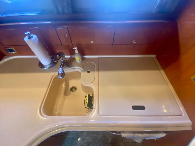 Slide: The Image of 2001 Sea Ray 510 Sundancer kitchen sink with faucet and countertop. - 48