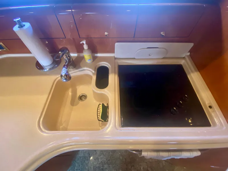 Slide: The Image of Kitchen area of 2001 Sea Ray 510 Sundancer yacht with sink and stove. - 49