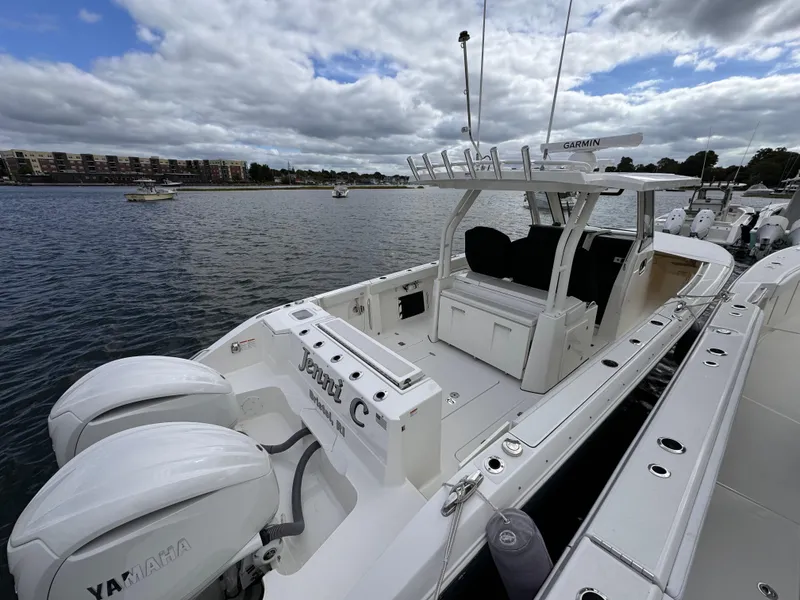Slide: The Image of 2023 Pursuit S 328 Sport boat with Yamaha engines docked on a cloudy day. - 10