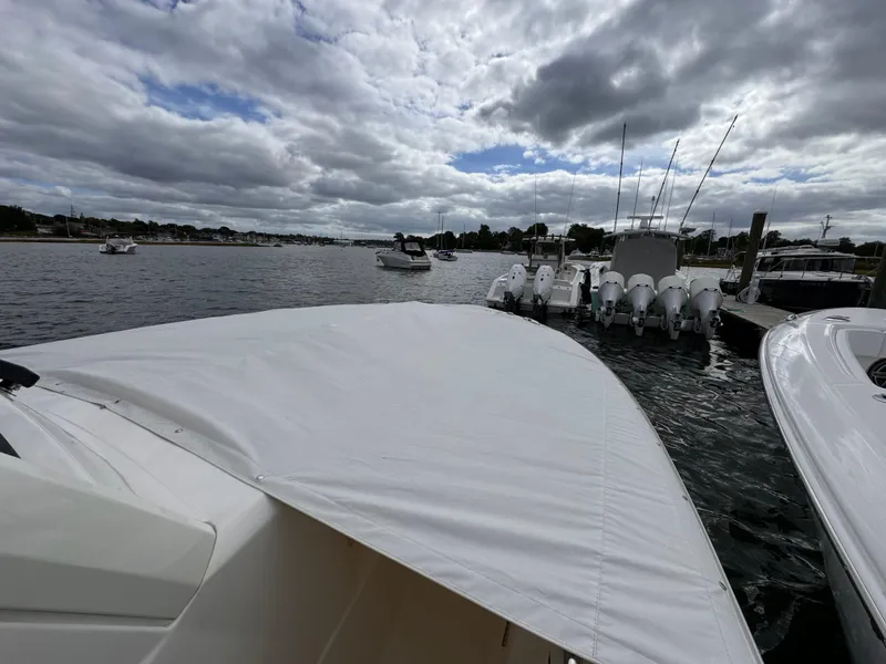 Slide: The Image of 2023 Pursuit S 328 Sport boat docked on a cloudy day. - 14