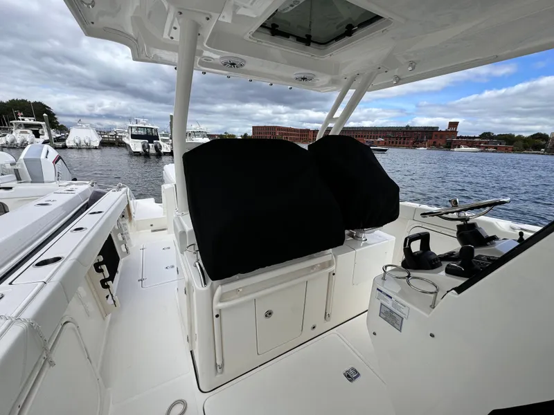Slide: The Image of 2023 Pursuit S 328 Sport boat interior with covered seats and steering console. - 15