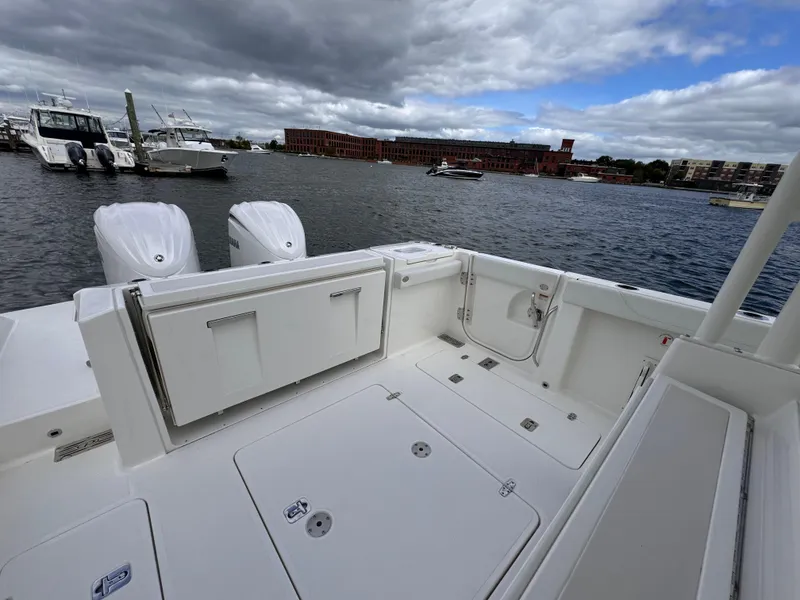 Slide: The Image of 2023 Pursuit S 328 Sport boat docked on a cloudy day. - 16