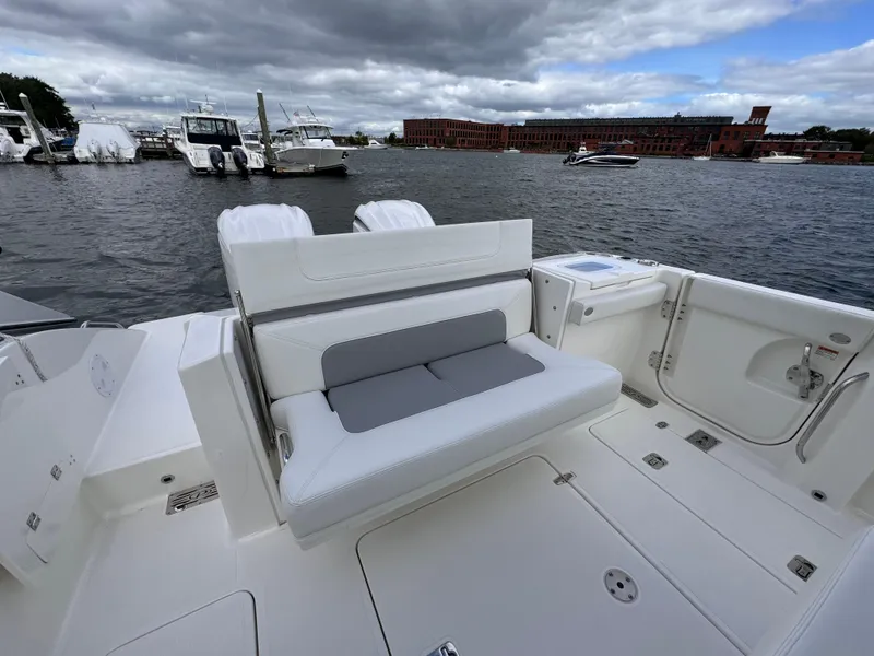 Slide: The Image of 2023 Pursuit S 328 Sport boat with seating, docked in a marina. - 18