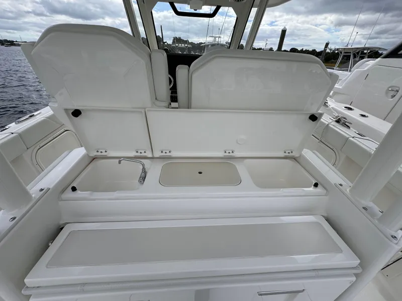 Slide: The Image of 2023 Pursuit S 328 Sport boat interior with open storage compartments. - 20