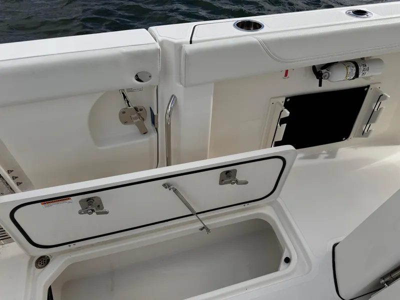 Slide: The Image of 2023 Pursuit S 328 Sport boat deck with storage compartment open. - 21