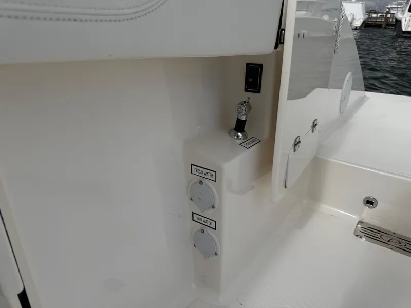 Slide: The Image of 2023 Pursuit S 328 Sport boat interior detail with water and power outlets. - 31
