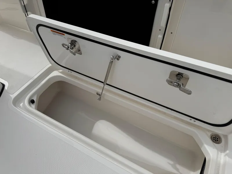 Slide: The Image of Open storage compartment on 2023 Pursuit S 328 Sport boat. - 32