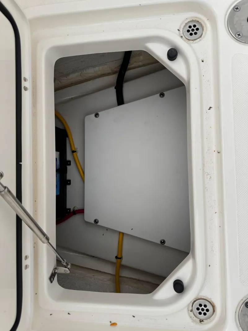 Slide: The Image of 2023 Pursuit S 328 Sport boat storage compartment with wiring. - 41